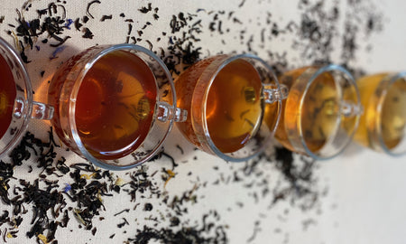 Black loose leaf tea in a glass cup